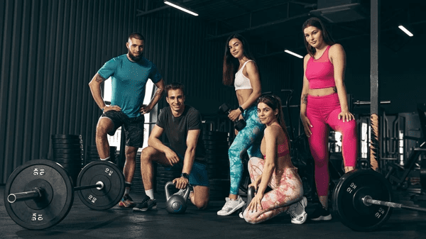 Group of young friends doing sports, training, posing at gym indoors | pharmaqo.to